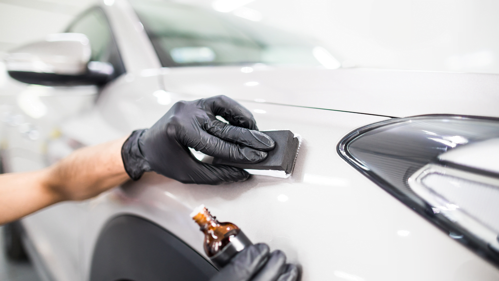 Person polishing vehicle.