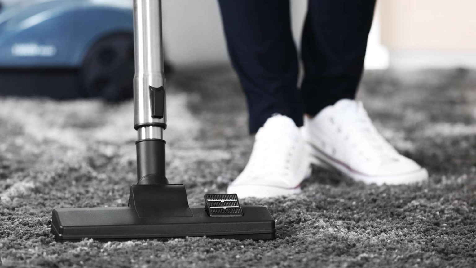 Specialist performing carpet cleaning services in a Minneapolis, MN living room after winter foot traffic