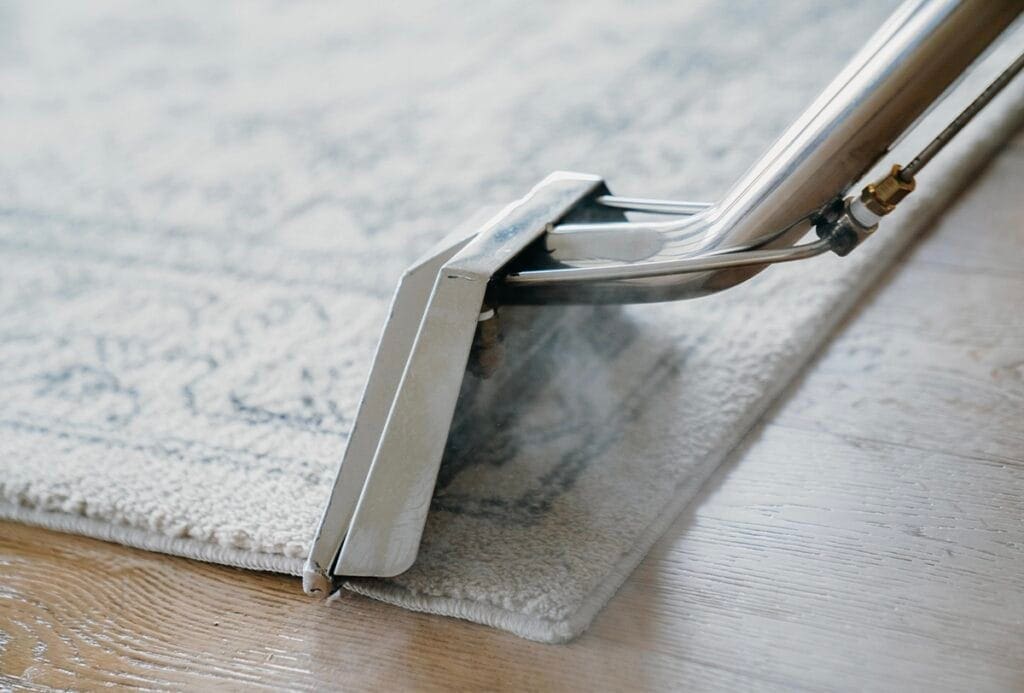 Technician performing carpet cleaning services in a Phoenix, AZ townhouse hallway with heavy foot traffic