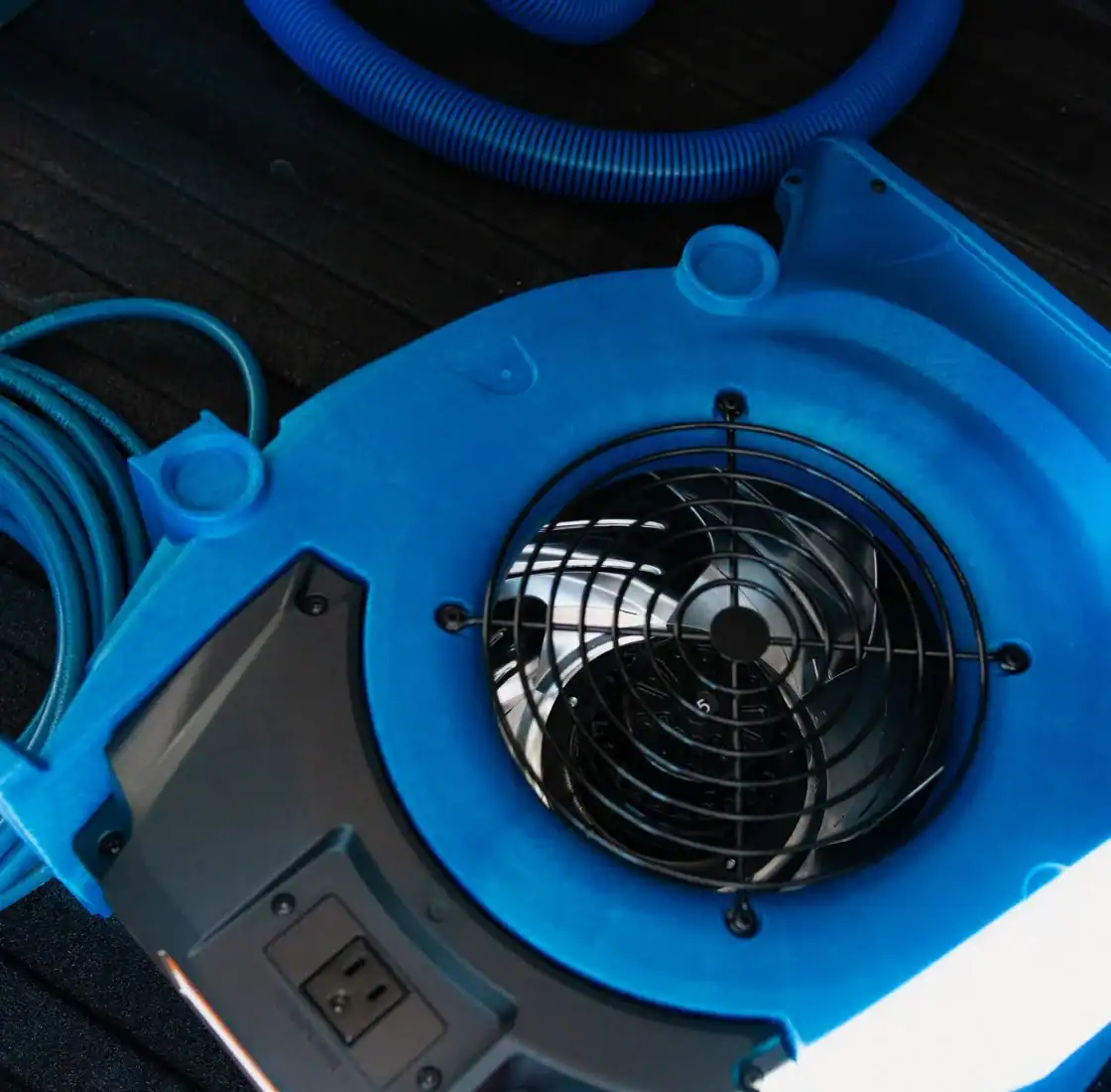 Close up of a blue air mover used to dry carpet after cleaning