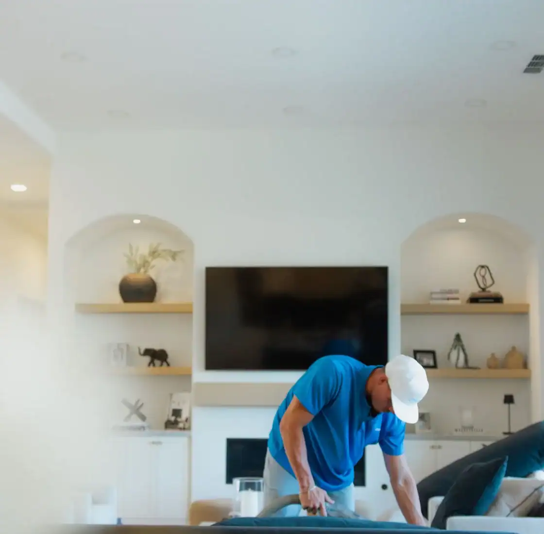 Coconut Cleaning technician working on the floor of a bright living room