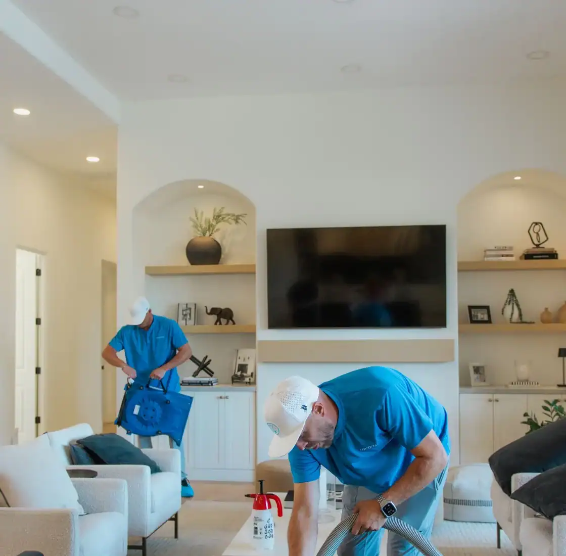 Two Coconut Cleaning technicians working in a bright living room