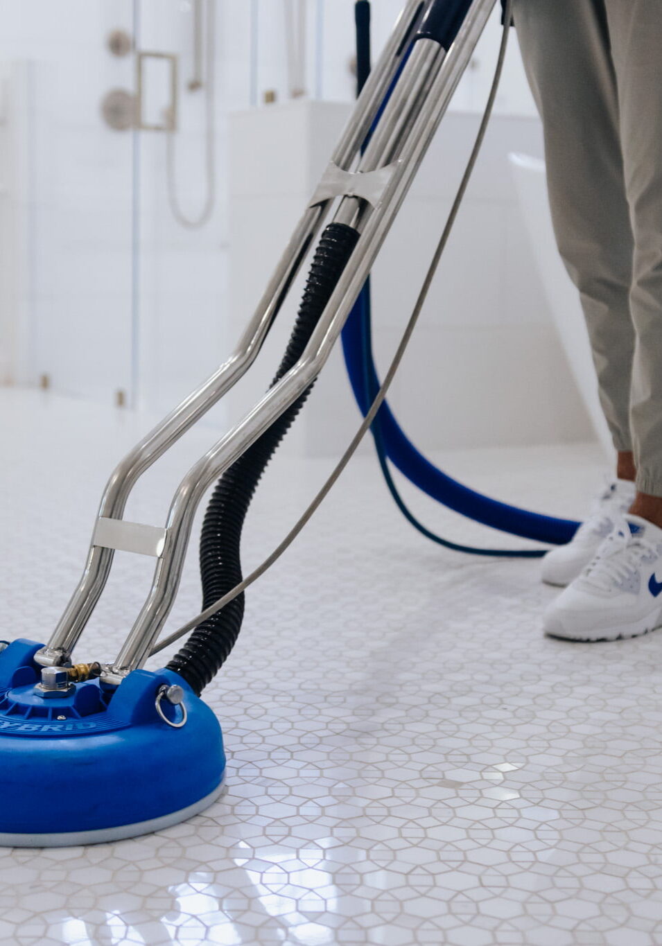 CC-292 Person polishing tile floor in bathroom.